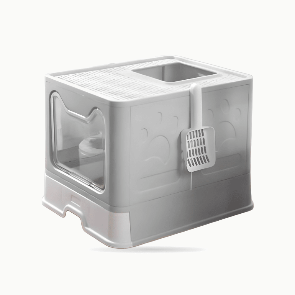 Maison de toilette grise fermée vue de trois quarts, porte transparente et pelle à litière accrochée sur le côté